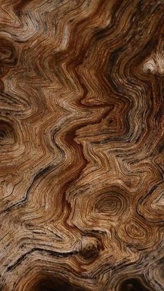 an abstract wood grain pattern on the surface of a piece of art work that looks like waves