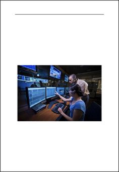 two people sitting in front of computer monitors