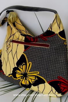 This exquisitely re-fashioned Shoulder Bag has been beautifully crafted by blending Ethnic print fabric with gently re-purposed, reclaimed, and upcycled items. This Multicolour cultural handbag is the perfect style for both work and evenings out. #gennhaio #handmadebag #ethnicshoulderbag #slouchhandbag #abutterflybag #etsyeller #fauxleatherbag Slouch Bags, Heart Fashion, Ethnic Print, Black Handbags, Shoulder Handbags, Handmade Bags, Gifts For Girls, Printing On Fabric