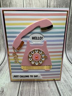 a card with a pink phone on it and the words hello, just calling to say