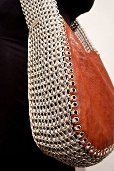 a woman's purse with metal rivets on it