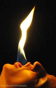 a woman's face is lit by a matchstick