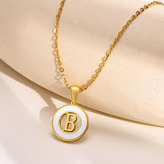 Adorn yourself with this stylish and unique personalizable Hollow Shell Circle YourLetter Pendant Necklace. Crafted with gold-colored stainless steel, this necklace features a flashy shell design with a letter of your choice centered in a hollow circle. Customize your look with any letter A-Z. An eye-catching accessory that will turn heads. White Stainless Steel Necklaces For Personalized Gift, Personalized White Stainless Steel Necklaces, Trendy White Letter Jewelry, Trendy White Letter Shaped Jewelry, Trendy Personalized White Charm Necklaces, Trendy White Jewelry With Letter Print, Personalized White Stainless Steel Charm Necklace, Trendy White Stainless Steel Necklace, Trendy White Round Necklace