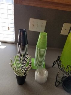 there are many different cups on the counter