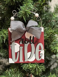 a christmas ornament hanging on a tree with the words noel ride in it