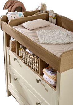 a baby crib with an open drawer in the middle