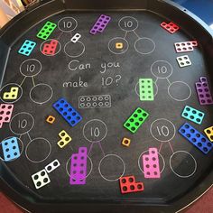 a black tray with colorful dices on it that says can you make 10?