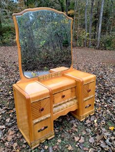 an antique vanity with mirror and drawers in the woods