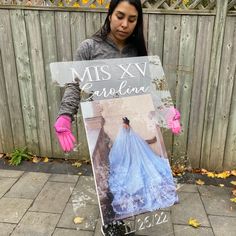 a woman holding up a sign that says miss xv carolina on it and wearing gloves