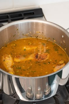 a large metal pot filled with food on top of a stove