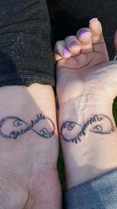 two people holding hands with tattoos on their wrists that say happy mother and daughter