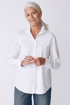 Kal Rieman Ginna Box Pleat Shirt in White Stretch on Model Front view hands touching Classic Blouse With Lapel Collar, Modern Fitted Top With Fold Down Collar, Timeless Business Tops, Timeless Business Top With Fold-down Collar, Timeless Business Top With Fold Down Collar, Timeless Spread Collar Top For Daywear, Timeless Daywear Top With Spread Collar, Timeless Top With Spread Collar For Daywear, Fitted Blouse With Fold-down Collar For Daywear