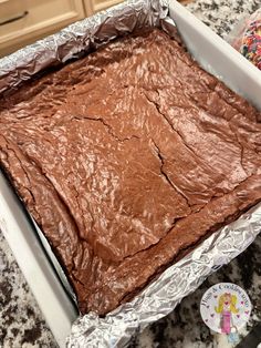 a pan filled with chocolate cake sitting on top of a counter