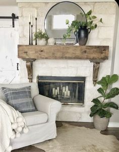 a living room filled with furniture and a fire place in front of a white brick wall