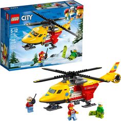 a lego city helicopter with people and vehicles in it's box, next to the set