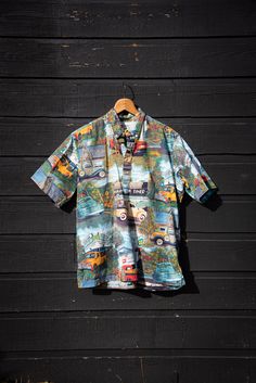 "Vintage Reyn Spooner -American Classics Hawaiian shirt! 100% Cotton polo in an old school 1950's drive in, general store, diner and vintage trucks print. In great vintage condition, light wear - no issues. Sizing + Measurements: Marked a size Large Chest (pit - pit & doubled): 50\" Overall Length: 28\" All measurements are taken flat and then doubled when appropriate. Please let us know if you have any questions about sizing or fit. Please check out the shop policies and feel free to contact us Retro Cotton Hawaiian Shirt With Retro Print, Cotton Hawaiian Shirt With Retro Print And Camp Collar, Retro Short Sleeve Shirt With Camp Collar, Vintage Cotton Printed Short Sleeve Shirt, Vintage Printed Cotton Short Sleeve Shirt, Retro Hawaiian Shirt With Camp Collar, Retro Cotton Hawaiian Shirt With Vintage Print, Vintage Printed Cotton Camp Shirt, Vintage Printed Camp Shirt With Relaxed Fit