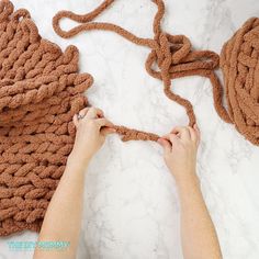 someone is crocheting the rope on top of an object that looks like a purse