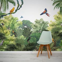 a wall mural with tropical trees and birds painted on it's sides, in front of a white chair