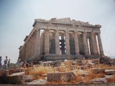 people standing in front of an ancient building