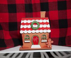 a gingerbread house with a wreath on top