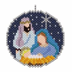 a cross stitch ornament with the image of jesus and mary in blue, surrounded by stars