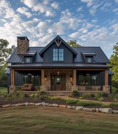 a large house with a metal roof and stone steps leading to the front porch area