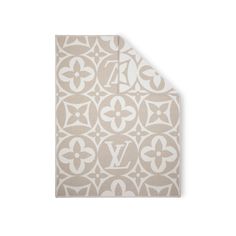 a beige and white rug with the letter v on it