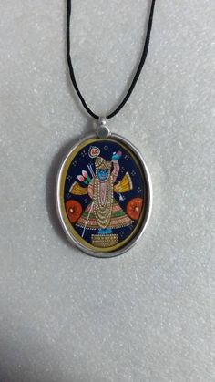 Handmade Miniature Painting Deity Shreenath ji Kind of Kristina Pendant Covered by 92.5 Sterling Silver Glass Framed Beautiful Oval Shape Pendant Necklace. Made by My Shop Member. Primary Colour Is Silver Pendant Length With Loop 4.5 cm. Pendant Width 3.2 cm Pendant Weight 7.gms. It's a Totally Handmade Glass Framed Necklace. Covered By 92.5 Sterling Silver And Glass. Used Natural Water Colours on Paper Sheet. Traditional Oval Handmade Necklaces, Traditional Oval Handmade Necklace, Traditional Handmade Oval Pendant Necklace, Traditional Handmade Oval Necklace, Traditional Blue Oval Necklace, Spiritual Silver Oval Pendant Necklaces, Silver Meenakari Pendant Necklace, Spiritual Jewelry With Oxidized Oval Pendant, Sterling Silver Locket For Puja