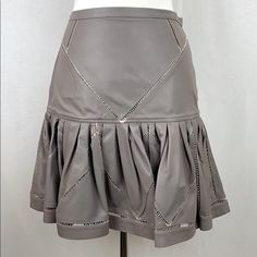 Retail $950 - Made In Italy - 100% Buttery Soft, Medium-Weight Italian Leather - Open Stitch Work - Top Half Of Skirt Is Lined With Same Buttery Soft Leather - Bottom Half Is Unlined, Pleated & Flared - Back Logo Zipper (7.5" Long) - Hook & Eye Closure - Waist To Hem: 18.5” - Waist: 32" - Hips: 37" - Hem Circumference: 140" - Professional Leather Clean Only Luxury Fitted Pleated Skirt, Luxury Fitted Skirt, Luxury Pleated Skirt For Spring, Designer Fitted Leather Skirt, Luxury Leather Skirt, Luxury Fitted Leather Skirt, Taupe Leather Mini Skirt, Stitch Work, Leather Mini Skirt