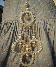 an old fashion dress with beaded decorations on it