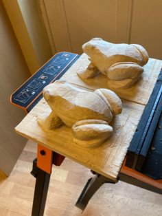 two wooden sculptures sitting on top of a table