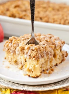 an apple crumb cake on a plate with a fork