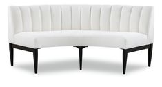 a white curved couch with black legs