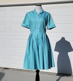 "Who doesn't love a vintage Sears dress? This beauty is a lovely light blue shirt dress with a double breasted front panel with topstitching detail.  This would make a lovely every day dress, or it is perfect for an Alice in Wonderland vintage look or cosplay!! Beautiful pleating on the skirt, original thread belt loops are still on the dress, but the original belt is not included. It would look great with any number of other belts, so many colors would go beautifully with this blue!  Front butt Retro Blue Button-up Dress, Classic Blue Shirt Dress With Buttons, Fitted Collared Light Blue Dress, Blue Vintage Dress With Buttons For Spring, Spring Blue Vintage Dress With Buttons, Light Blue Fitted Collared Dress, Classic Blue Shirt Dress For Summer, Fitted Blue Shirt Dress With Placket, 1950s Style Vintage Dress For Spring Workwear