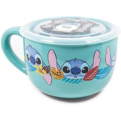 a blue cup with an image of stitch and stitch on the side, sitting in front of a white background