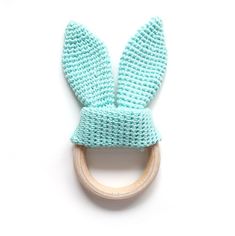 a blue knitted bunny ear on a wooden ring