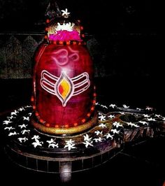 a large red and gold decorated vase sitting on top of a black table with white stars around it