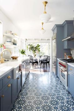 a kitchen with blue cabinets and white counter tops is featured in the instagram page