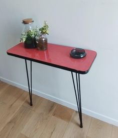 a red table with some plants on it