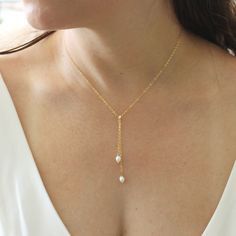 This elegant lariat necklace is great for brides! It features two oval, lustrous freshwater pearls that drop gracefully from the Y center into a double loop. A gorgeous chic necklace will be the perfect touch to make sure you look and feel your best on your big day!  P R O D U C T * D E T A I L S Genuine freshwater pearls 5.5mm Chain drop measures 2.5 and 3 inches Available in Sterling Silver, 14k Gold Fill  1.5mm dainty cable chain Cable chain is secured with a spring-ring clasp Hypoallergenic, lead-free & nickel-free. ** Our cultured pearls are carefully selected for their bright and lustrous qualities. Each pearl is unique meaning the size and shape may vary, handle your pearls with love, as they are delicate in nature. P A C K A G I N G + D E L I V E R Y Please allow 2-5 days for us to Elegant Teardrop Pendant Lariat Necklace For Wedding, Oval Pearl Drop Necklace For Wedding, Long Drop Pearl Pendant Necklace For Wedding, Wedding Long Drop Lariat Necklace With Pearl, Adjustable Lariat Necklace With Pearl Charm For Wedding, Elegant Oval Lariat Necklace As Gift, Minimalist Lariat Drop Necklace For Wedding, Elegant Oval Lariat Necklace For Gift, Minimalist Drop Lariat Necklace For Wedding