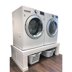 two washers are stacked on top of each other in front of a dryer