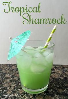 a green drink in a glass with an umbrella on the top and text describing tropical shamrock cocktail