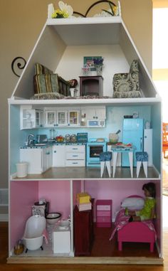 a doll house with furniture and accessories in it