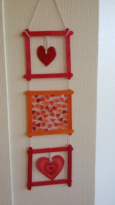 three frames with hearts hanging on the wall