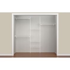 an empty closet with white shelves and wooden floors