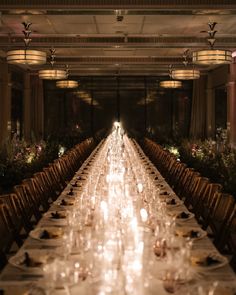 the long table is set with many plates and place settings for people to sit at