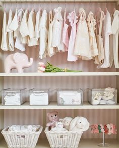 a closet filled with lots of baby clothes