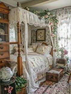 a bedroom with a canopy bed and floral wallpaper on the walls, along with an antique chest of drawers