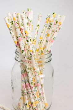 several floral paper straws in a glass jar