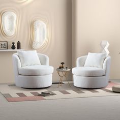 two white chairs sitting on top of a rug